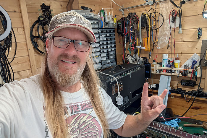 Dave Barlow, professional guitar amplifier technician, repairing a valve guitar amplifier in his specialist workshop